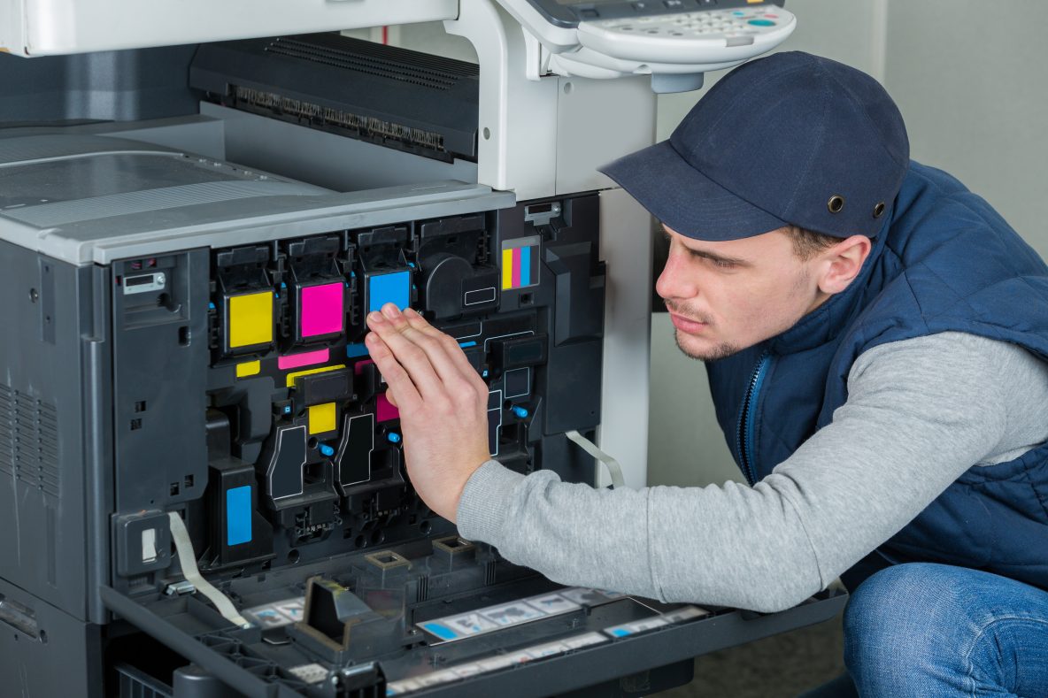technician repairing digital photocopier printer machine